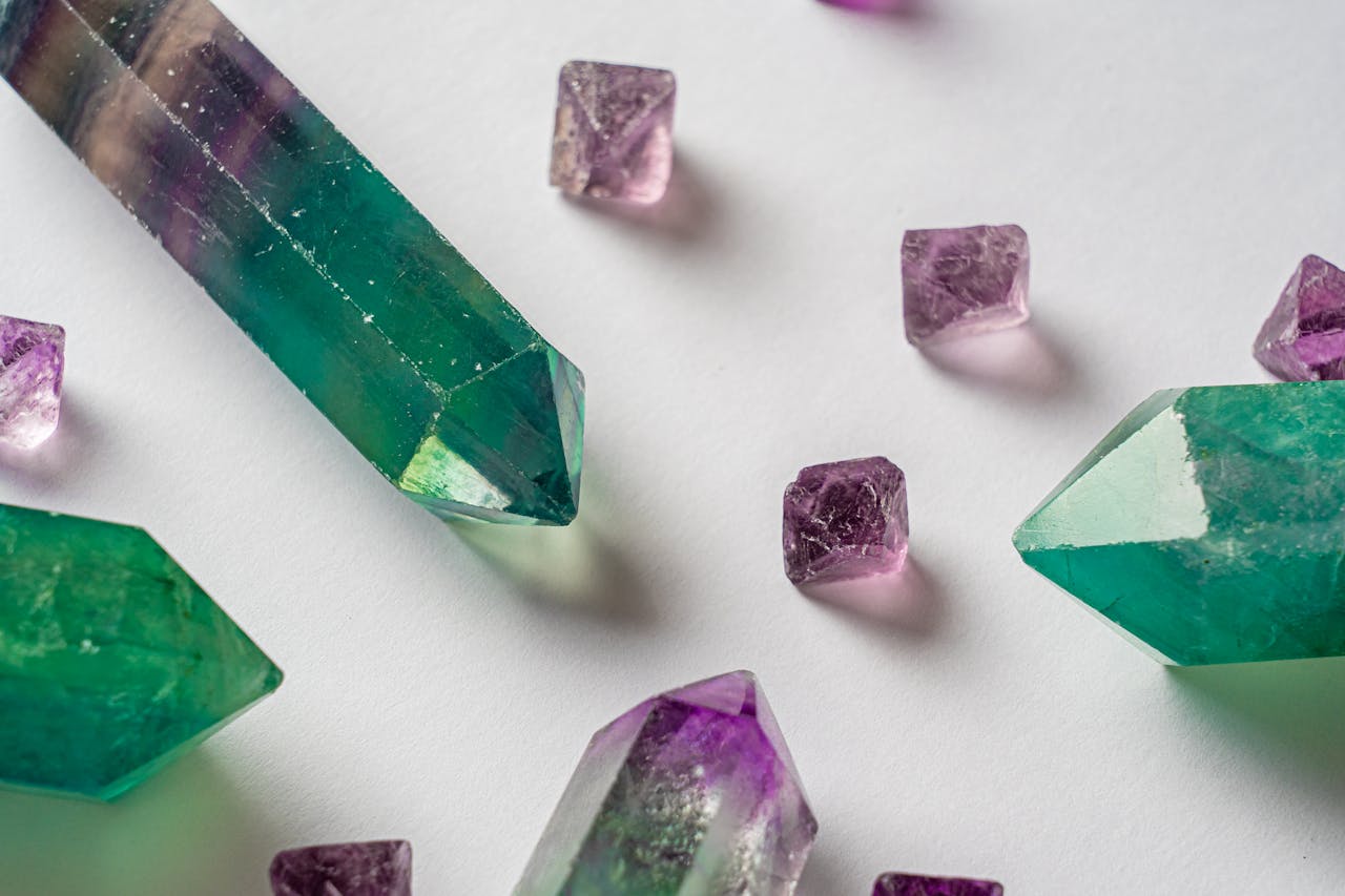 creative-01 Discover intricately detailed green fluorite and purple amethyst crystals against a white backdrop.
