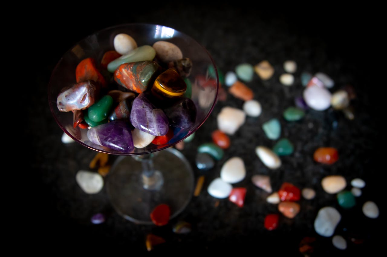 mobile-01 Close-up of vibrant semi-precious stones arranged inside a wine glass.